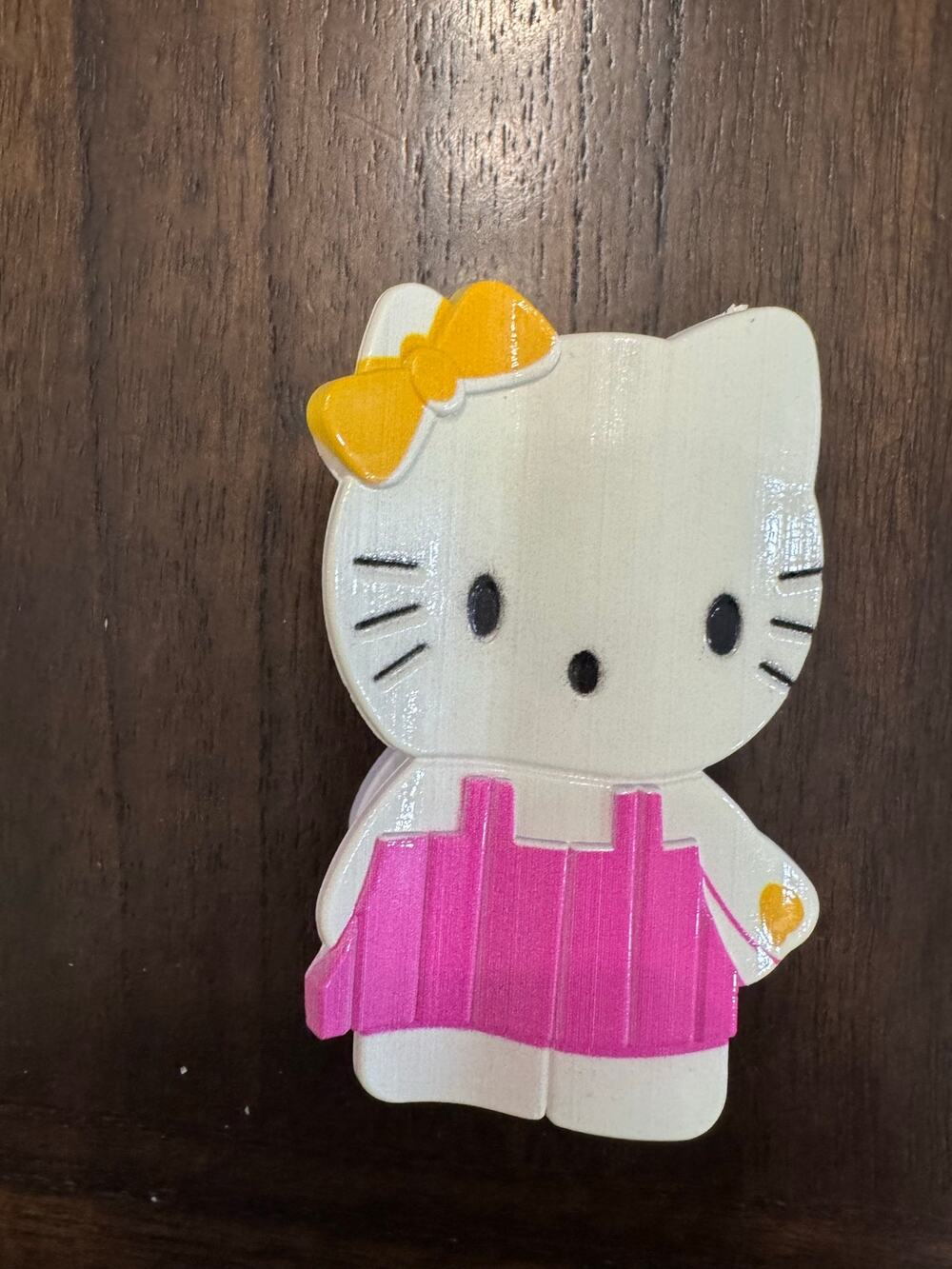 Large Hello Kitty hair claw clip with pink skirt and yellow bow